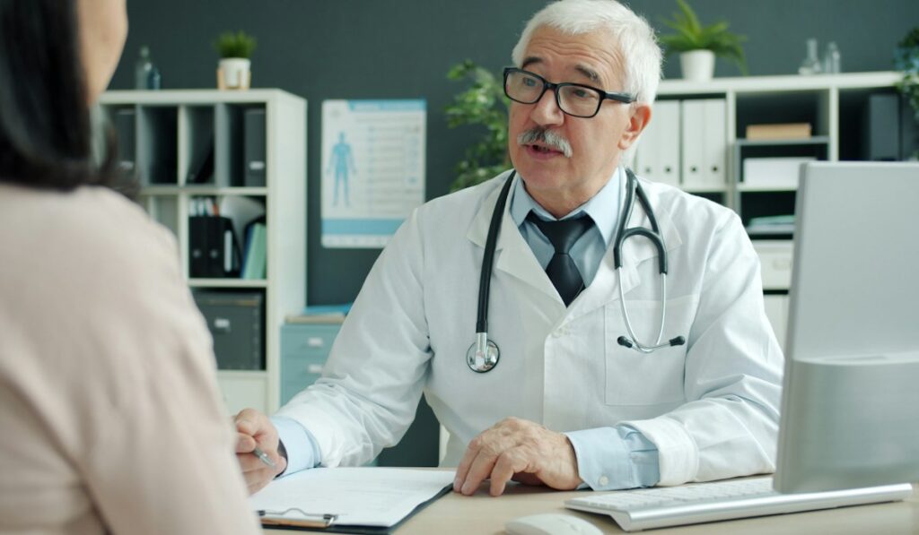 Doctor with patient – health insurance coverage